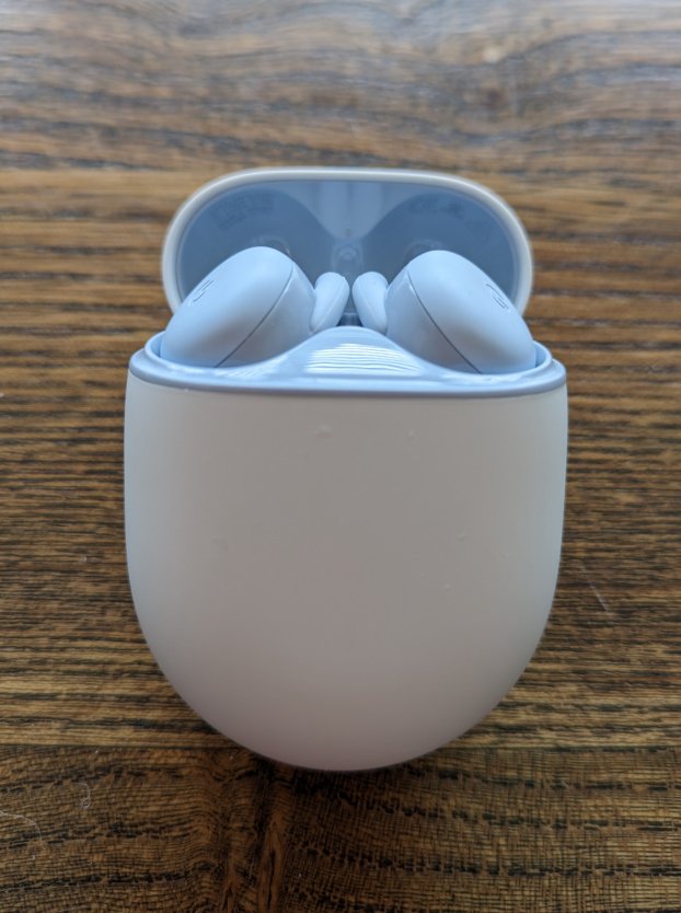 A pair of earbuds in a holder